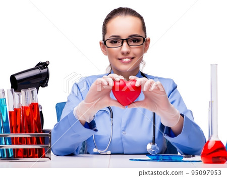 Young doctor with red heart isolated on white 95097953