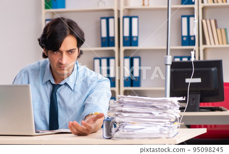 Young male employee in blood transfusion concept Young male employee in blood transfusion concept 95098245