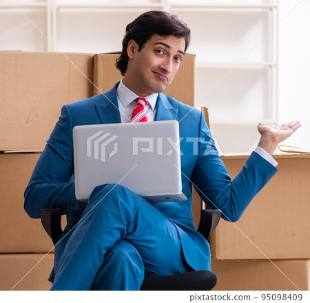Young handsome businessman moving to new workplace Young handsome businessman moving to new workplace 95098409