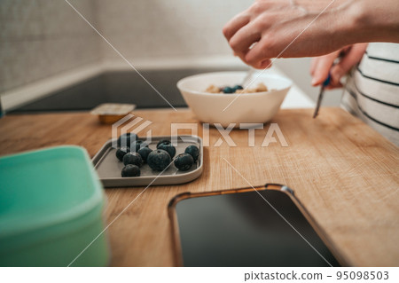 Housewife cooking healthy breakfast in the kitchen Housewife cooking healthy breakfast in the kitchen 95098503