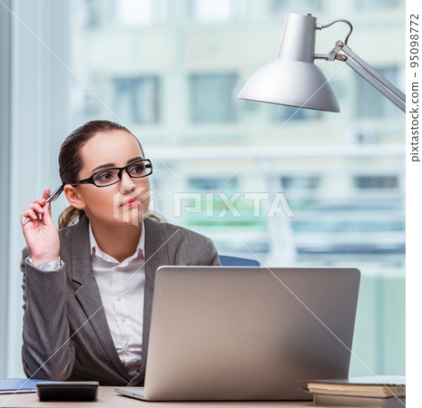 Young assistant working in the office Young assistant working in the office 95098772