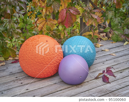 three slam balls on a backyard deck 95100060
