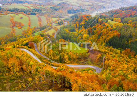 Picturesque autumn landscape with road between the hills. Picturesque autumn landscape with road between the hills. 95101680