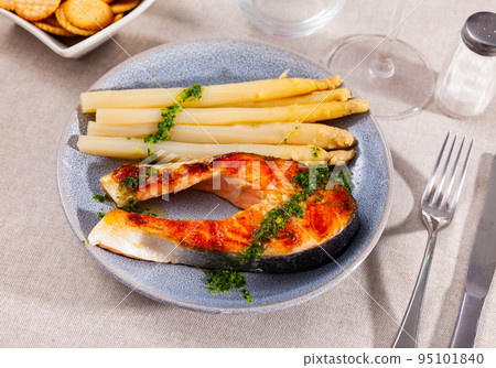 Grilled salmon steak with asparagus and pesto Grilled salmon steak with asparagus and pesto 95101840