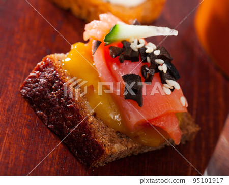 Canape with salmon and mango sauce Canape with salmon and mango sauce 95101917