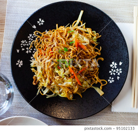 Japanise style noodles with vegetables yakisoba beautifully served in the bowl 95102133