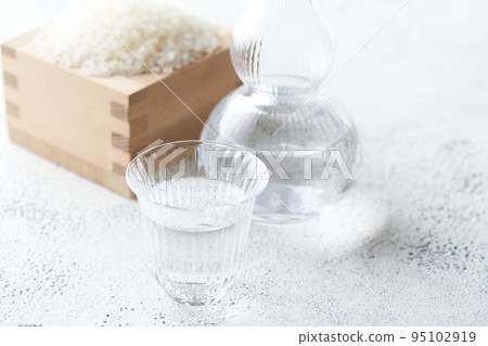 Japanese sake poured into the sake cup of the glass 95102919