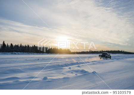 car driving on frozen river 95103579