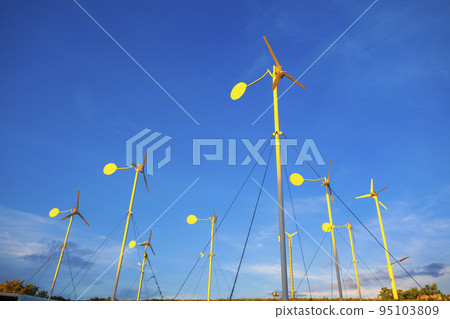 Wind turbines and solar panels in a big green field 95103809