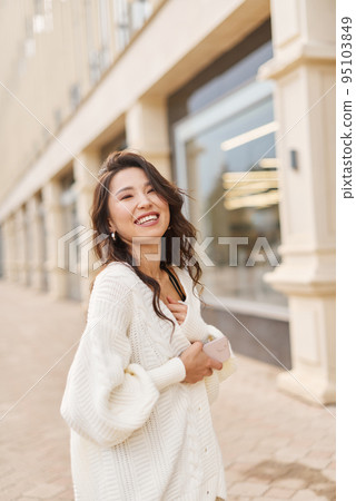 Glamour portrait attractive natural asian kazakh woman wearing white sweater Relaxing outdoor Glamour portrait attractive natural asian kazakh woman wearing white sweater Relaxing outdoor 95103849