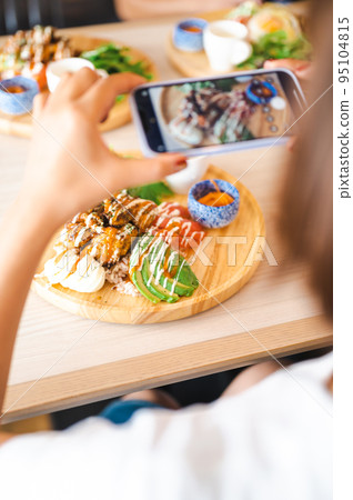 Woman taking pictures of food SNS smartphone Woman taking pictures of food SNS smartphone 95104815