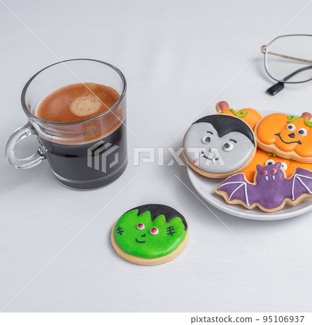 hot espresso coffee  or chocolate cup with funny Halloween Cookies. Happy Halloween day, Trick or Threat, Hello October, fall autumn, Traditional, party and holiday concept 95106937