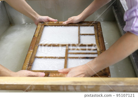 A woman making paper A woman making paper 95107121