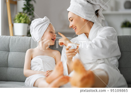 Mother and daughter after a bath 95109865