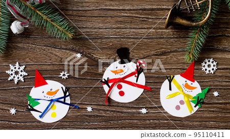 Christmas snowman merry gift. Handmade. Project of children's creativity, handicrafts, crafts for kids. Top view flat lay background. 95110411