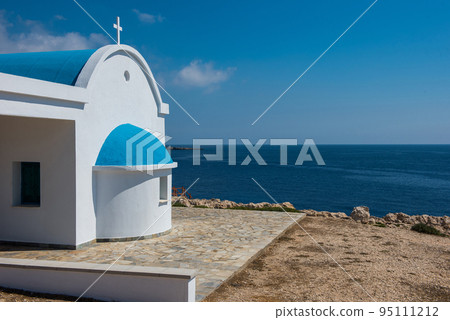 Traditional white chapel with a blue roof on the seaside. Agioi Anargyroi, Cyprus Traditional white chapel with a blue roof on the seaside. Agioi Anargyroi, Cyprus 95111212