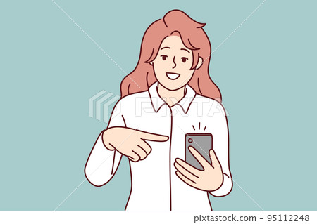 Smiling woman point at mobile notification  95112248