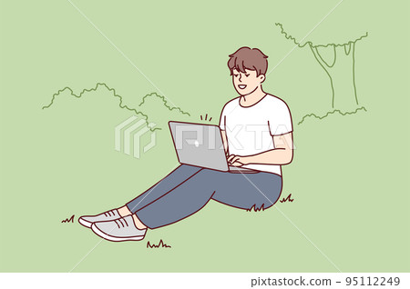 Smiling man sit in park work on laptop  95112249