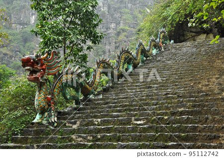 Carved stone dragon. Ascending staircase to Hang Mua pagoda, Ninh Binh, Vietnam Carved stone dragon. Ascending staircase to Hang Mua pagoda, Ninh Binh, Vietnam 95112742