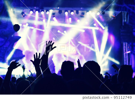 Crowd at a music concert, audience raising hands up Crowd at a music concert, audience raising hands up 95112749