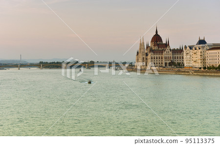 Budapest parliament at sunset near the Danube river 95113375