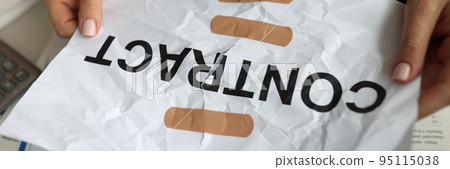 Manager hands holding band-aid paper contract closeup Manager hands holding band-aid paper contract closeup 95115038