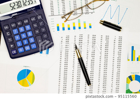Top view office table desk. Financial report. Flat lay. Workspace with Business office supplies, Accounts number on the data paper, diagrams, pen, glasses, calculator. Copy space for text. Top view 95115560