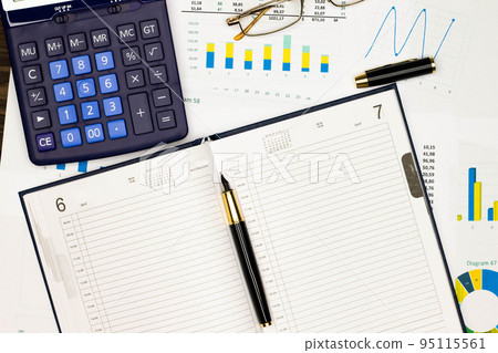 Top view office table desk. Financial report. Flat lay. Workspace with Business office supplies, numbers and empty sheet of diary, diagrams, pen, glasses, calculator. Copy space for text. Top view 95115561