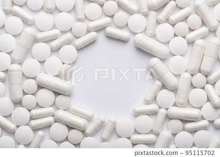 White pills and capsules with copy-space in center top view White pills and capsules with copy-space in center top view 95115702