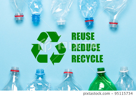 Recycling symbol and plastic bottles on blue background top view Recycling symbol and plastic bottles on blue background top view 95115734