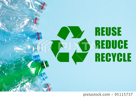Single use plastic bottles and recycling symbol with reuse reduce recycle text on blue background Single use plastic bottles and recycling symbol with reuse reduce recycle text on blue background 95115737