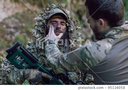 special operations soldiers team preparing tactical and communication gear for action battle. Long distance sniper team in checking gear for action 95116058