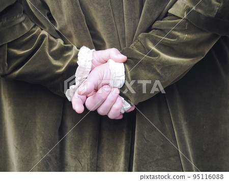 crossed hands man wearing medieval dress detail 95116088