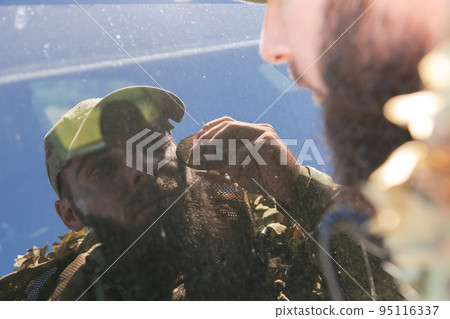 special operations soldiers team preparing tactical and communication gear for action battle. Long distance sniper team in checking gear for action 95116337