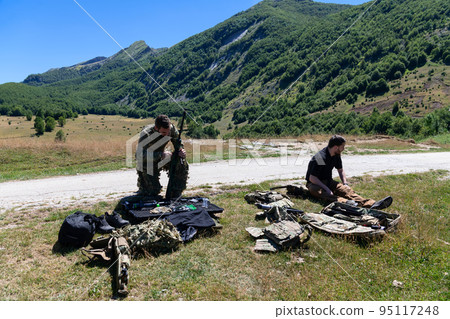 special operations soldiers team preparing tactical and communication gear for action battle. Long distance sniper team in checking gear for action 95117248