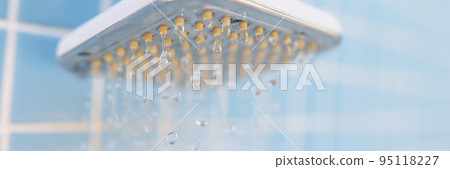 Drops of water from the head of a steel shower, close-up 95118227