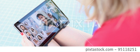 A woman by the pool holds a tablet on her lap, blurry A woman by the pool holds a tablet on her lap, blurry 95118251
