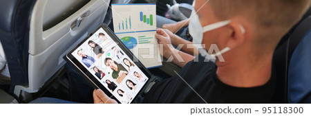 Businessman with a tablet and documents in an airplane 95118300