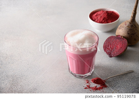 Beetroot latte or pink moon milk latte in glass cup on gray background. Great warming drink. 95119078