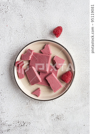 Pink or ruby chocolate, trendy dessert on a white plate Pink or ruby chocolate, trendy dessert on a white plate 95119081
