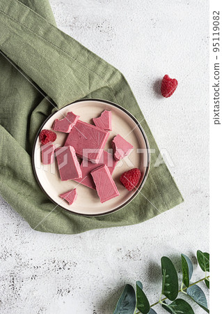 Pink or ruby chocolate, trendy dessert on a white plate Pink or ruby chocolate, trendy dessert on a white plate 95119082