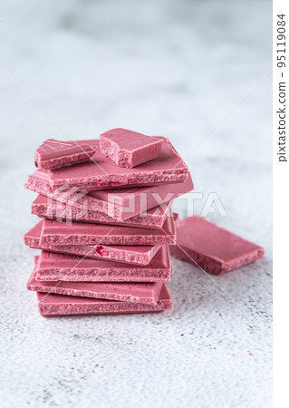 Pink or ruby chocolate, trendy dessert on grey background Pink or ruby chocolate, trendy dessert on grey background 95119084