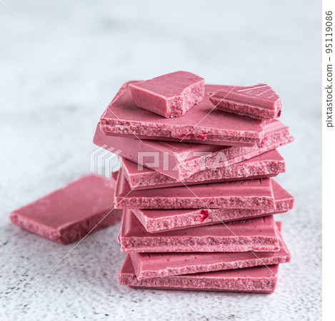 Pink or ruby chocolate, trendy dessert on grey background Pink or ruby chocolate, trendy dessert on grey background 95119086