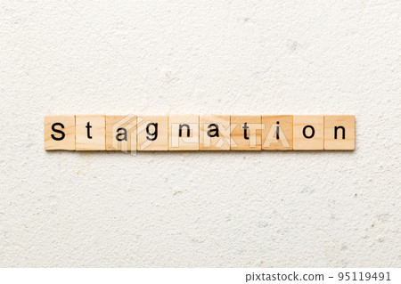 stagnation word written on wood block. stagnation text on cement table for your desing, concept 95119491