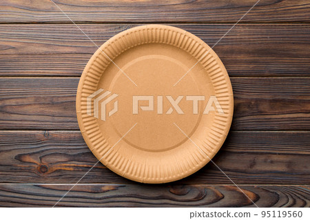 Top view of eco paper plate on wooden background. Empty space for your design Top view of eco paper plate on wooden background. Empty space for your design 95119560