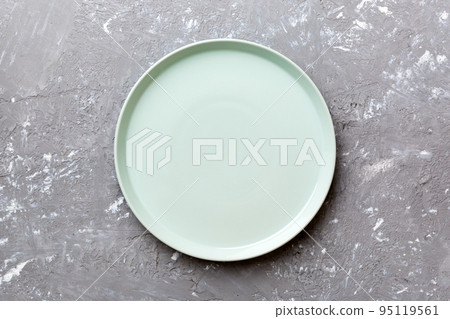Top view of empty blue plate on cement background. Empty space for your design Top view of empty blue plate on cement background. Empty space for your design 95119561