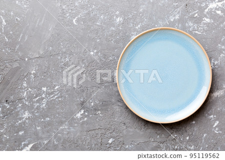 Top view of empty blue plate on cement background. Empty space for your design Top view of empty blue plate on cement background. Empty space for your design 95119562