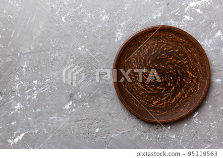 Top view of empty plate on cement background. Empty space for your design Top view of empty plate on cement background. Empty space for your design 95119563