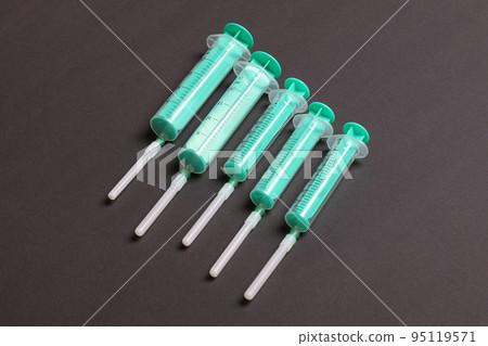 Top view of medical syringes on colorful background with copy space. Injection equipment concept Top view of medical syringes on colorful background with copy space. Injection equipment concept 95119571