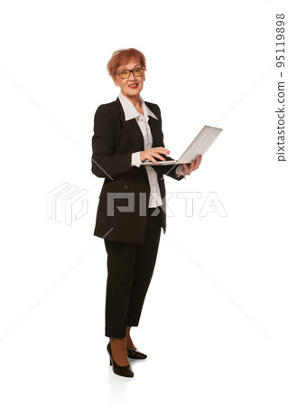 Portrait of confident senior executive manager. Stylish middle age woman in black business suit posing isolated on white background 95119898